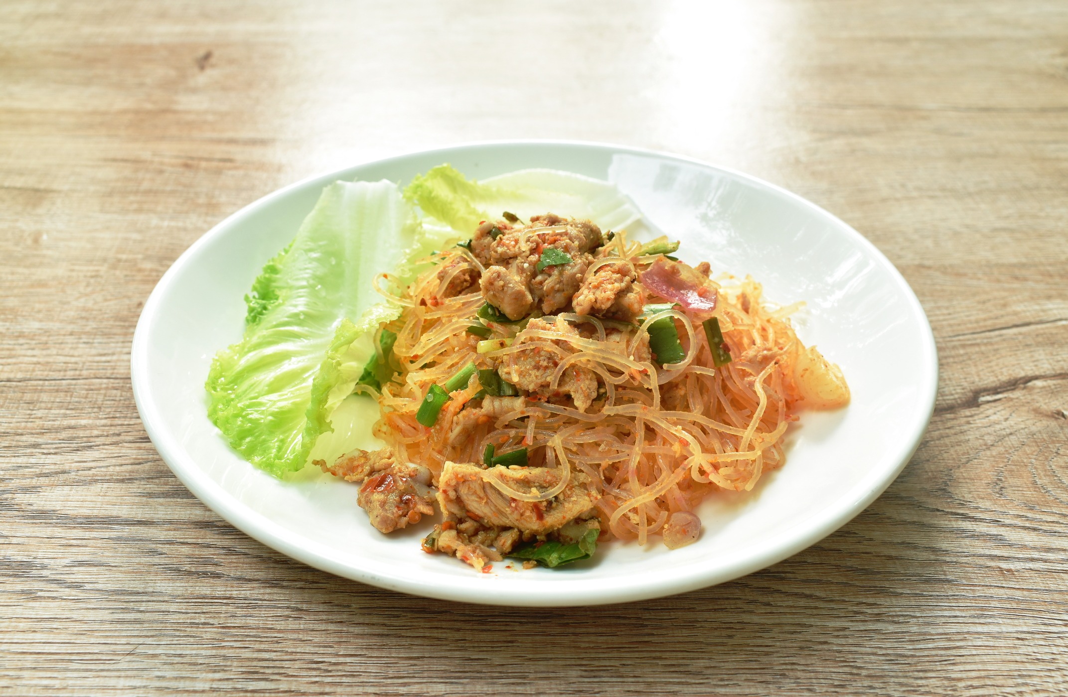 glass noodle with pork spicy salad and lettuce on plate 220843655