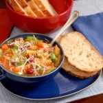 minestrone soup in blue bowl with italian bread 1302671