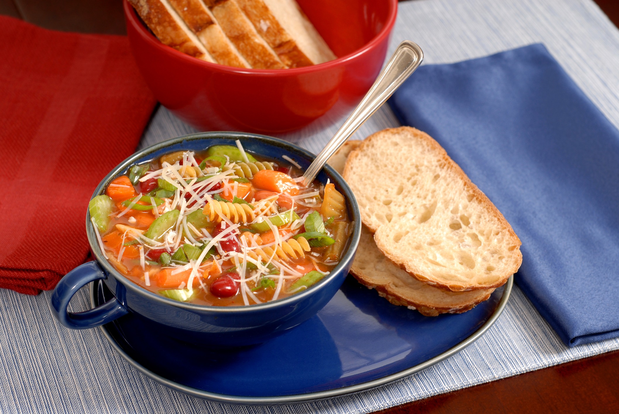minestrone soup in blue bowl with italian bread 1302671
